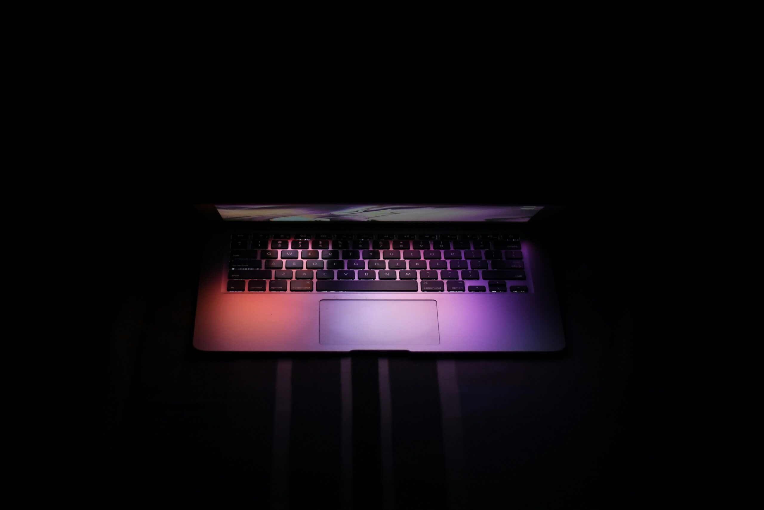 Lit up laptop in dark surroundings